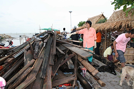 Residents point to what’s left of 81-year-old Muan Jitkawan’s house.